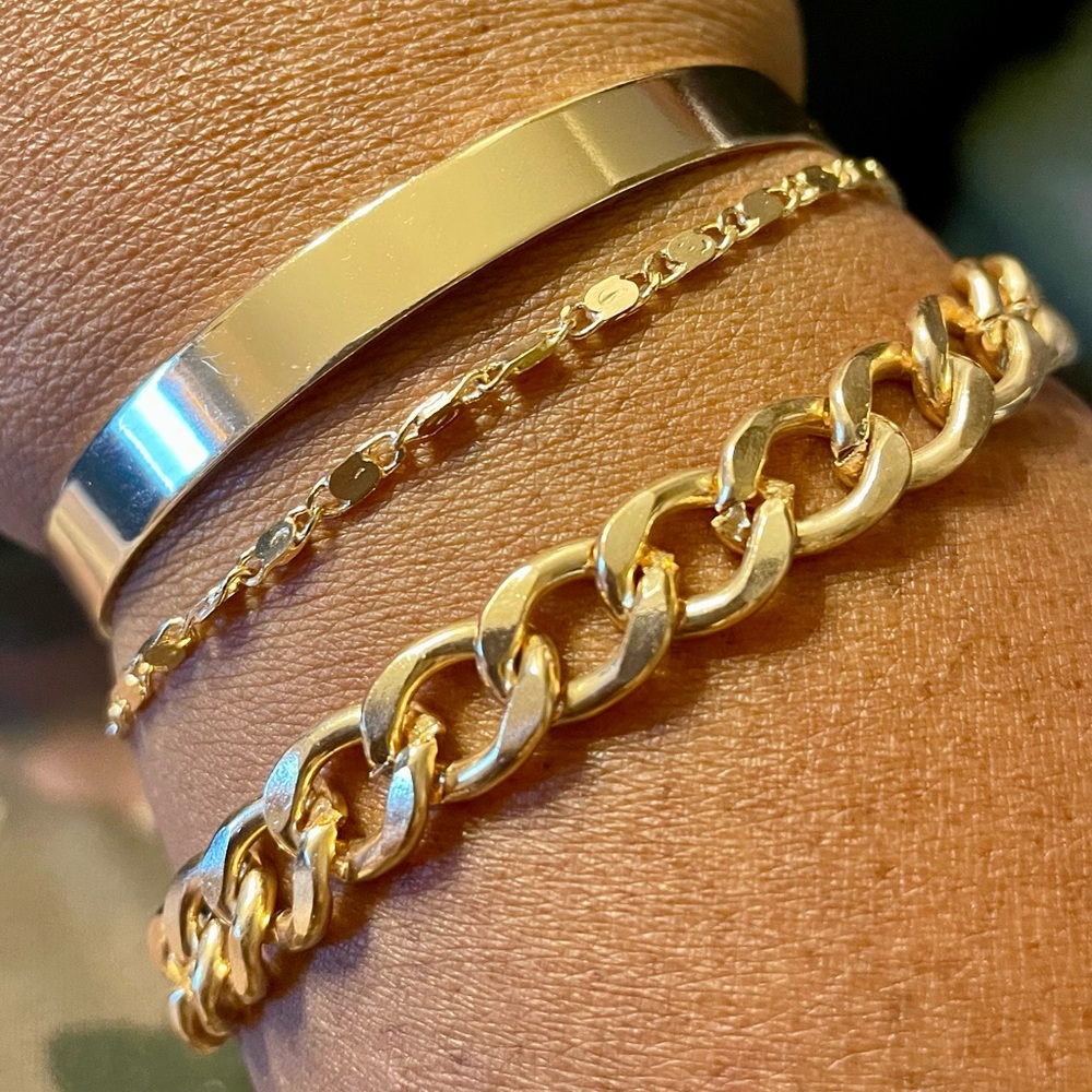 3 gold tone bracelets. Flat metal cuff, chain link, and mirror chain link. Bling